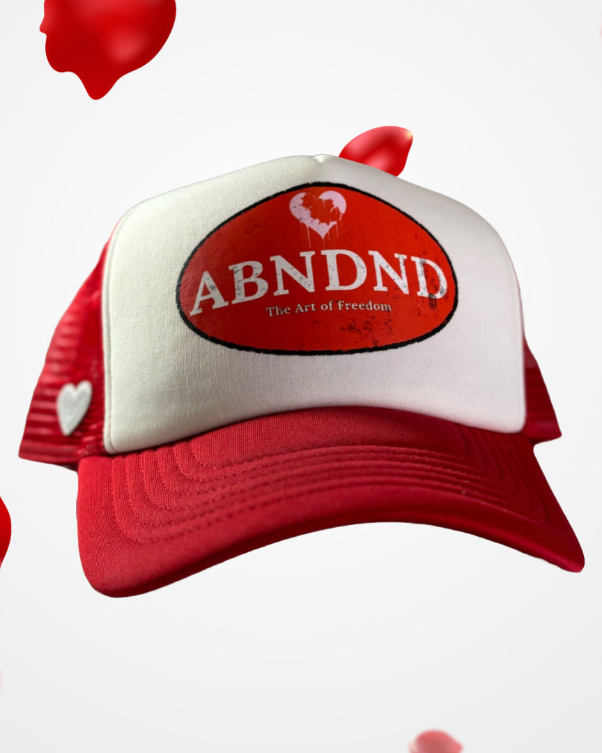 Heart & Freedom Trucker Hat with ABNDND patch, red mesh back, and embroidered heart detail.